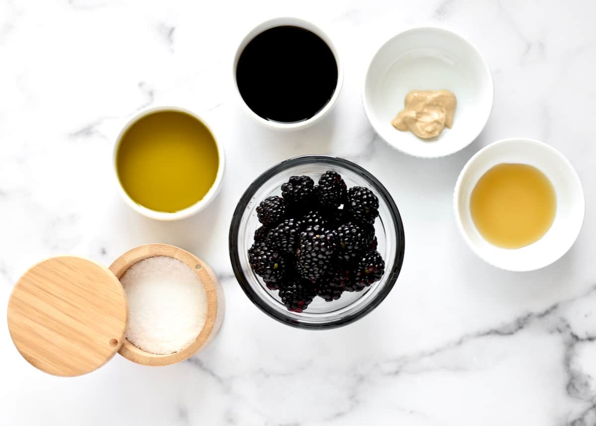 Ingredients for blackberry balsamic vinaigrette including blackberries, balsamic vinegar, olive oil, salt, maple syrup and dijon mustard.