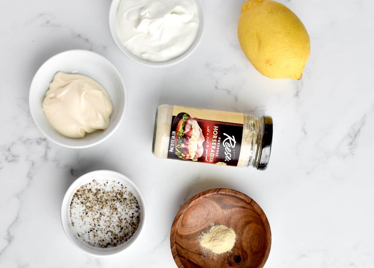 Ingredients for horseradish aoili on a marble background.