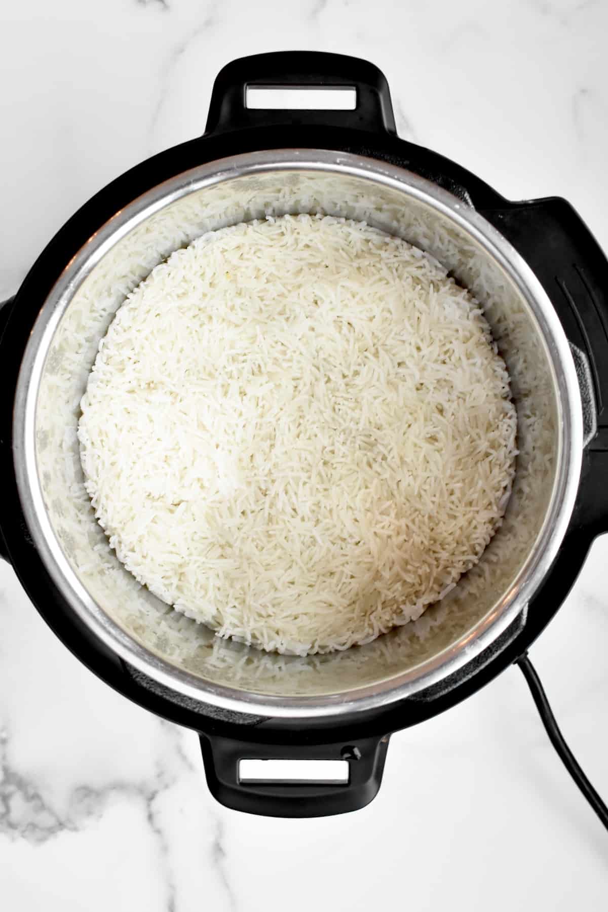 The inside of an instant pot showing cooked basmati rice.