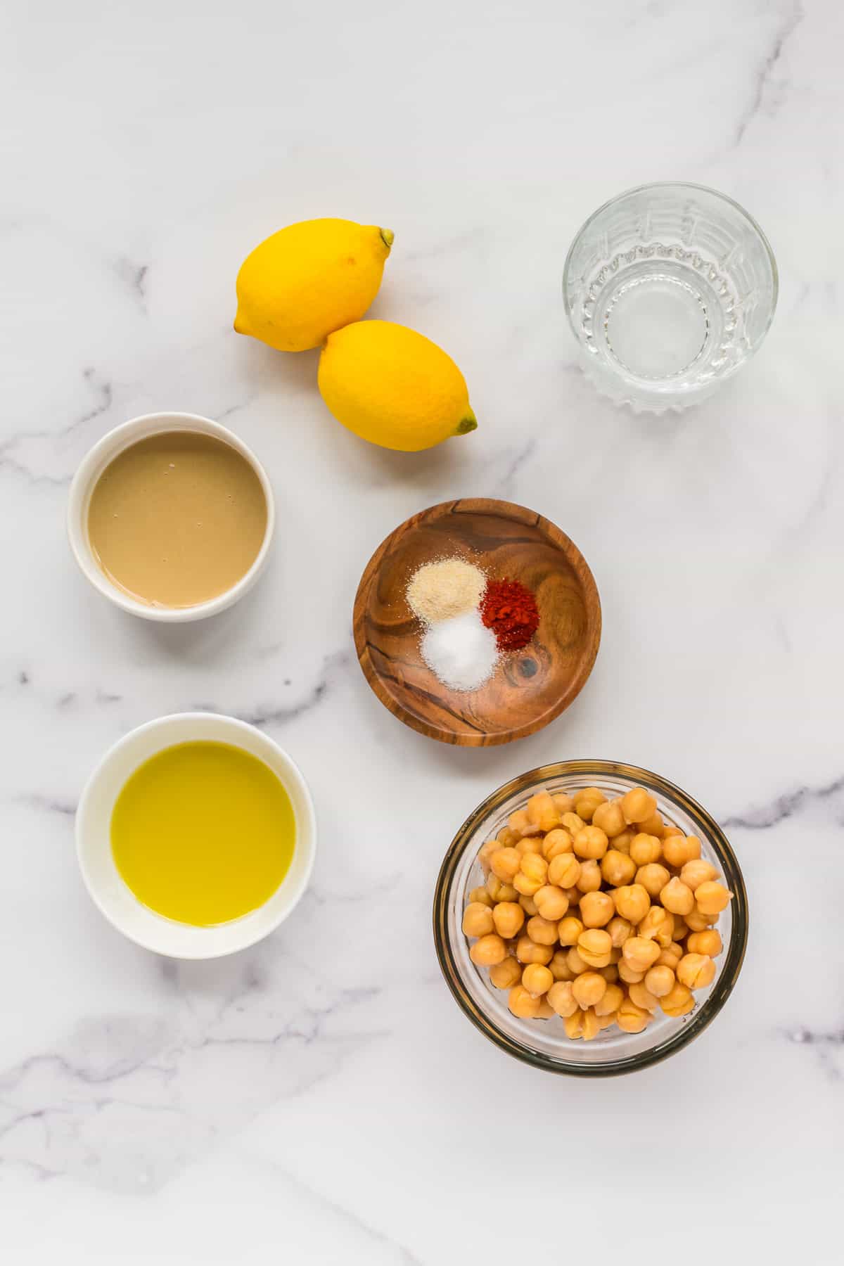 Ingredients for creamy lemon hummus individually portioned.