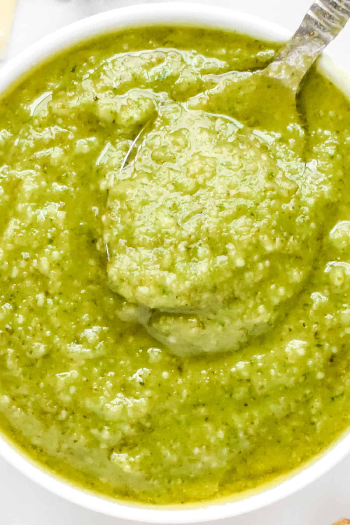 A close up view of creamy basil pesto without pine nuts.