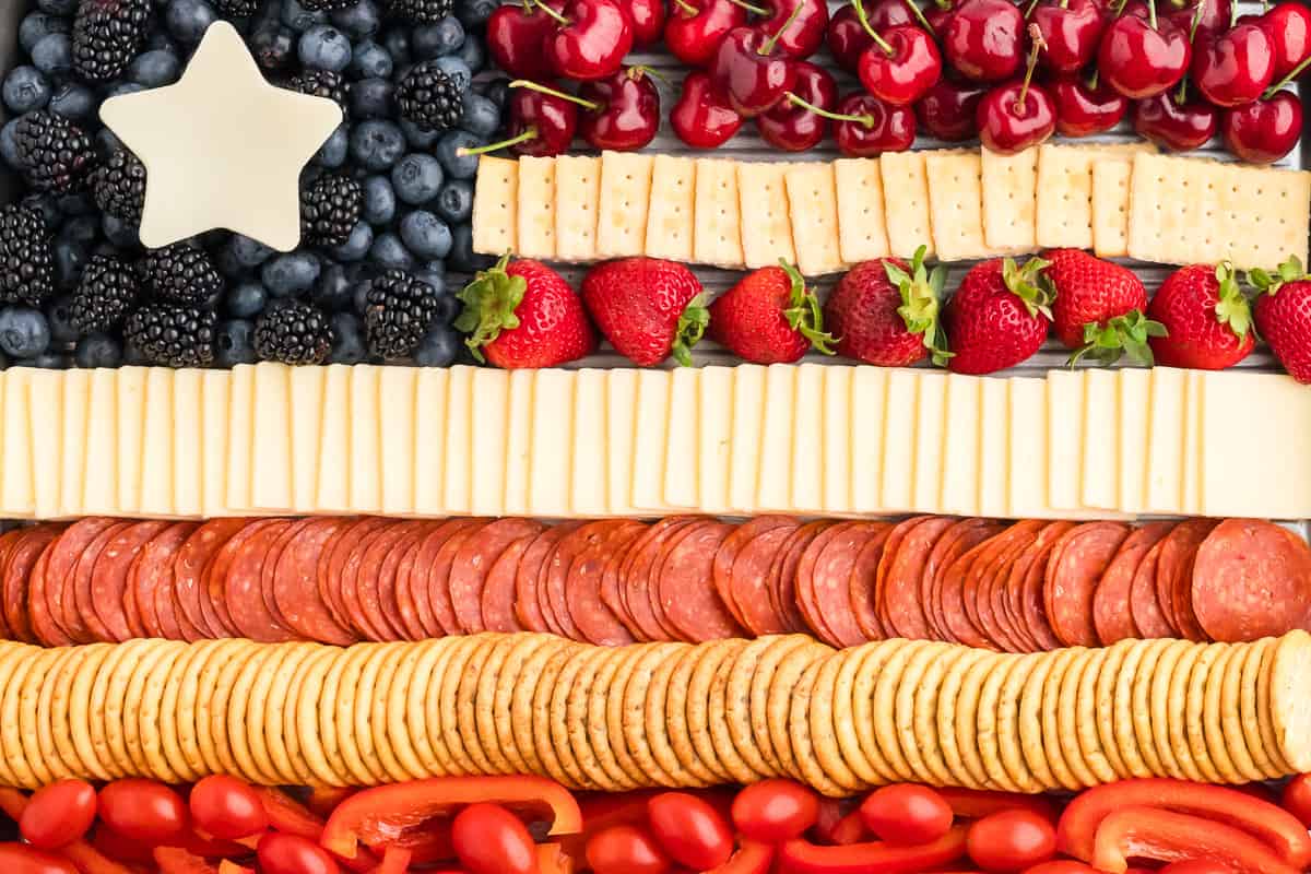 A close up view of a flag charcuterie board, showing the lines of ingredients.